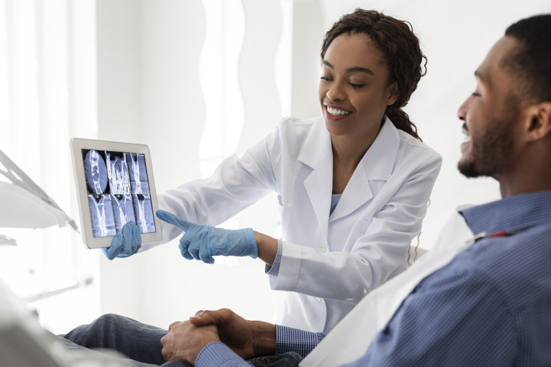 Dental specialist showing x rays to a patient